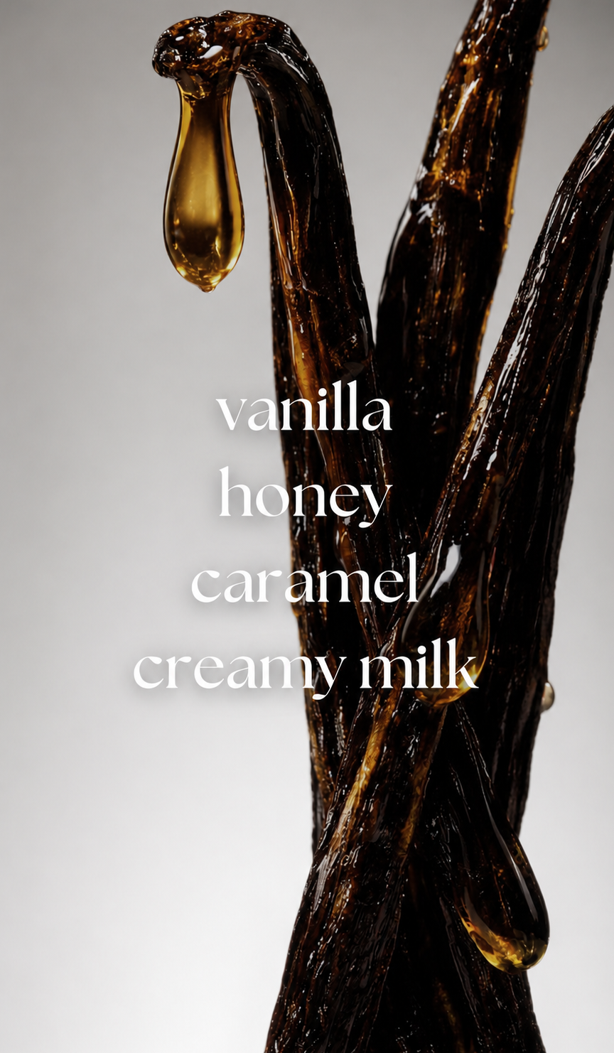 Vanilla beans with a drop of vanilla extract on a gray background, featuring text 'vanilla honey caramel creamy milk'.